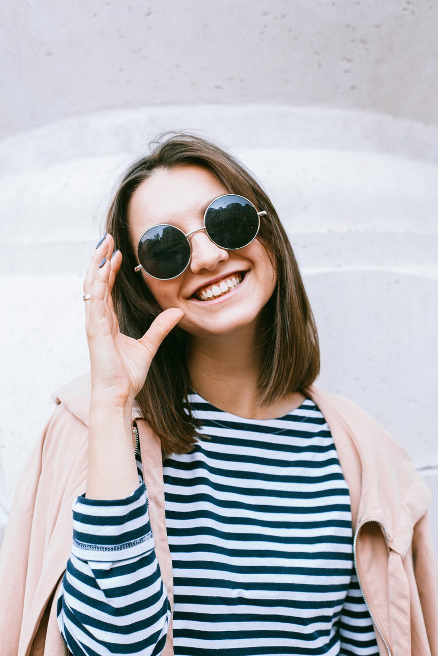 woman in white and black striped shirt wearing black sunglasses